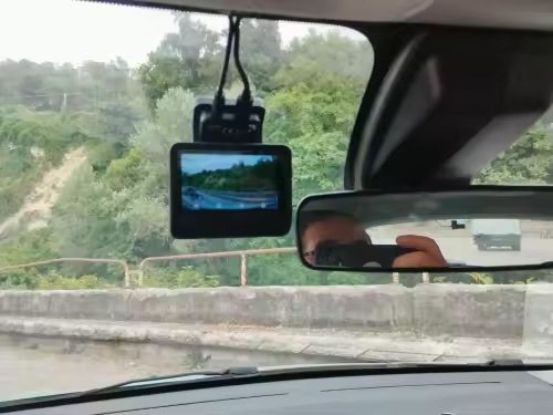 Dashcam Sentinelle Pro installée sur le pare-brise, écran allumé